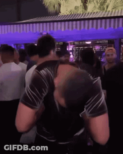 Man In Black Shirt Dancing In Crowd At Party GIF