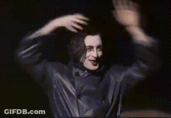 Man In Black Shirt Dancing In Dark Room GIF