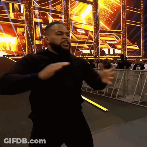 Man In Black Shirt Dancing In Front Of WWE Sign GIF