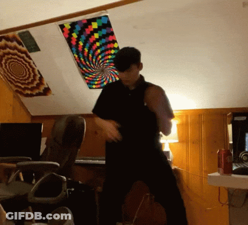 Man In Black Shirt Dancing Under Colorful Swirl Ceiling GIF