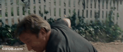 Man In Black Shirt Doing Push Ups In Front Of White Picket Fence GIF