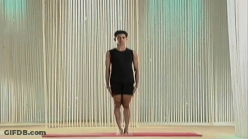 Man In Black Shirt Doing Yoga Pose On Mat GIF