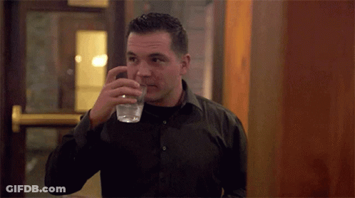 Man In Black Shirt Drinking From Glass GIF