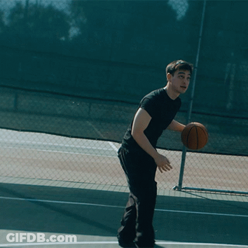 Man In Black Shirt Holding Basketball Over Head GIF
