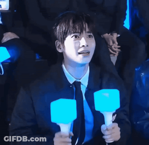 Man In Black Shirt Holding Blue Light Stick GIF