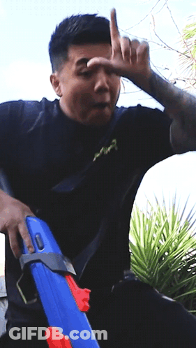 Man In Black Shirt Holding Blue Water Gun GIF