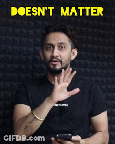 Man In Black Shirt Holding Cell Phone In Front Of Doesn't Matter Sign GIF