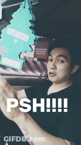 Man In Black Shirt Holding Christmas Tree Air Freshener Saying Psh GIF