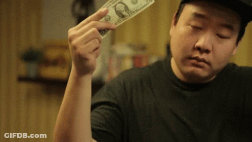 Man In Black Shirt Holding Dollar Bill GIF