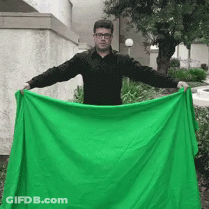 Man In Black Shirt Holding Green Blanket GIF