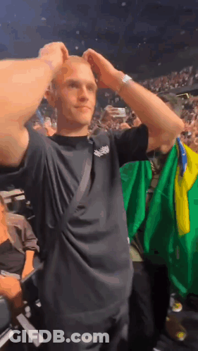 Man In Black Shirt Holding Green Yellow Flag GIF