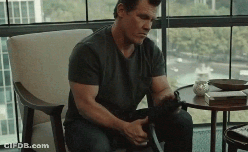 Man In Black Shirt Holding Gun GIF