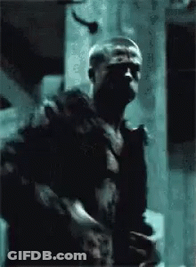 Man In Black Shirt Holding Gun GIF