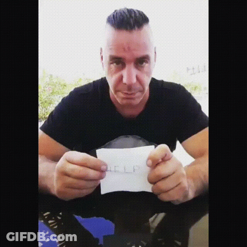 Man In Black Shirt Holding Help Paper GIF