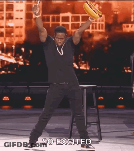 Man In Black Shirt Holding Hot Dog GIF