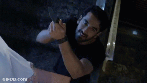 Man In Black Shirt Holding Knife GIF