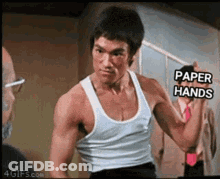 Man In Black Shirt Holding Knife And Spatula Getting Ready For Surgery GIF