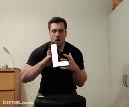 Man In Black Shirt Holding Large L GIF