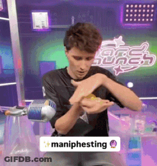 Man In Black Shirt Holding Maniphesting Sign GIF