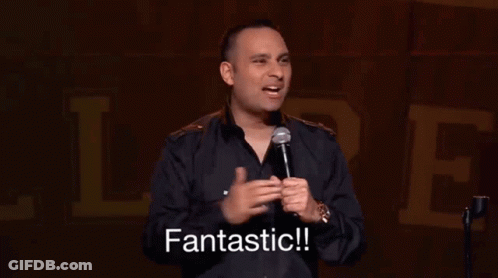 Man In Black Shirt Holding Microphone Says Fantastic GIF