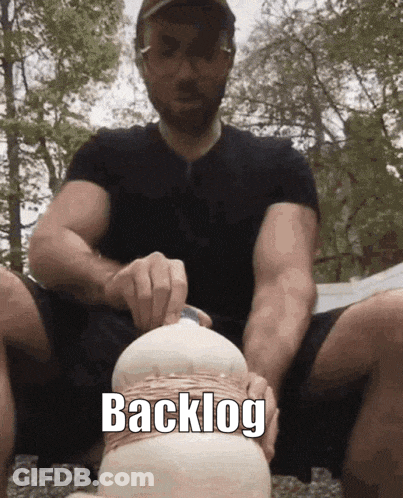 Man In Black Shirt Holding Object With Backlog GIF