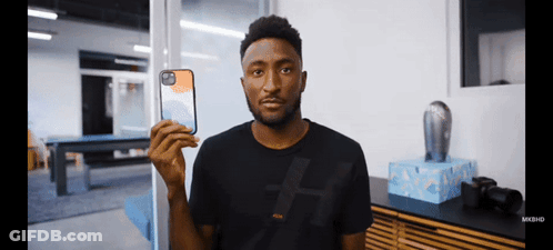 Man In Black Shirt Holding Phone GIF
