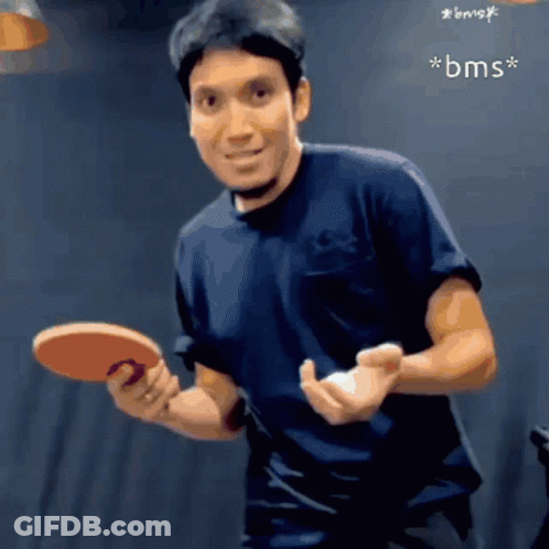 Man In Black Shirt Holding Ping Pong Paddle GIF