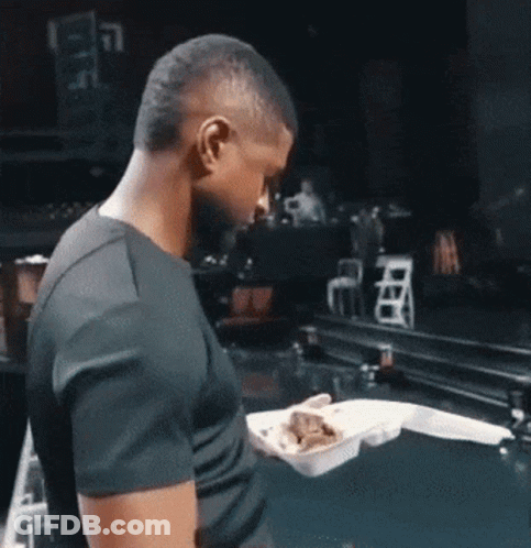 Man In Black Shirt Holding Styrofoam Food Container GIF