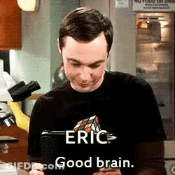Man In Black Shirt Holding Tablet Says Eric Good Brain GIF