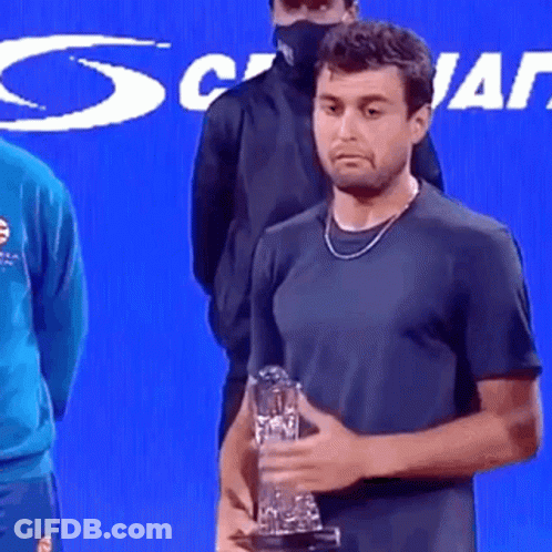Man In Black Shirt Holding Trophy GIF