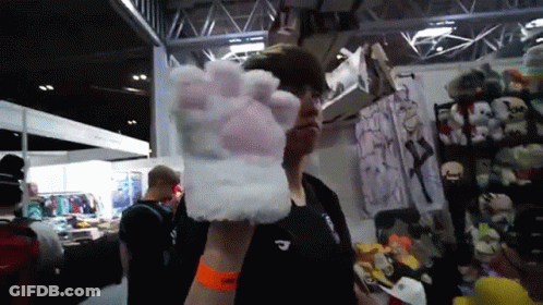 Man In Black Shirt Holding White Paw Glove GIF