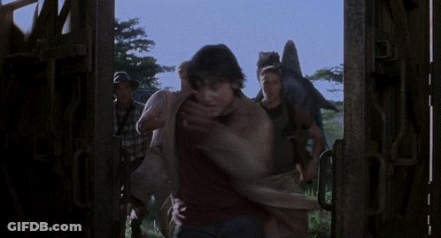 Man In Black Shirt Holding Woman In Purple Shirt GIF