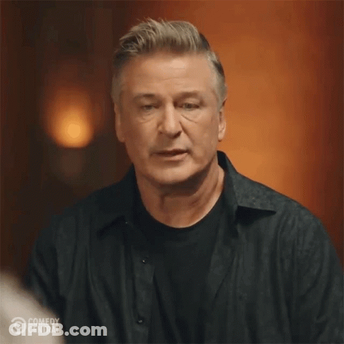Man In Black Shirt In Front Of Comedy Central Logo GIF