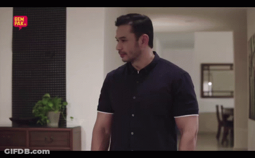 Man In Black Shirt In Front Of Gem Bak Sign GIF