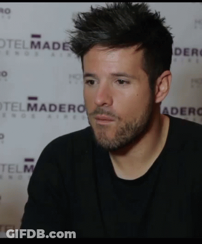 Man In Black Shirt In Front Of Hotel Madero Wall GIF
