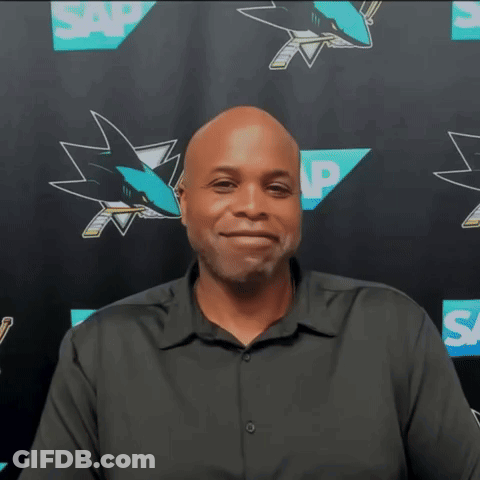 Man In Black Shirt In Front Of SAP Sharks Logos GIF