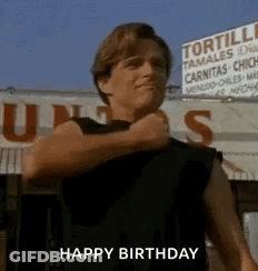 Man In Black Shirt In Front Of Tortilla Tamales Sign GIF