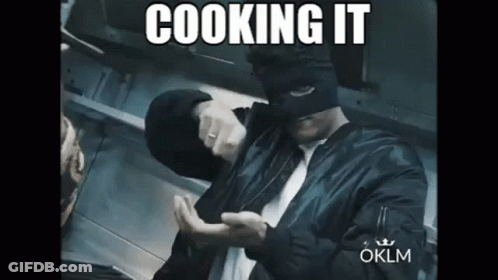 Man In Black Shirt In Kitchen With Pots GIF