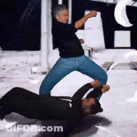 Man In Black Shirt Kicking Another Man GIF