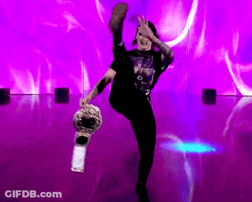 Man In Black Shirt Kicking Purple Wall GIF