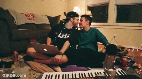 Man In Black Shirt Kissing Another Man GIF