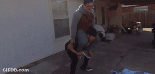 Man In Black Shirt Kneeling Over Woman In Blue Jacket GIF