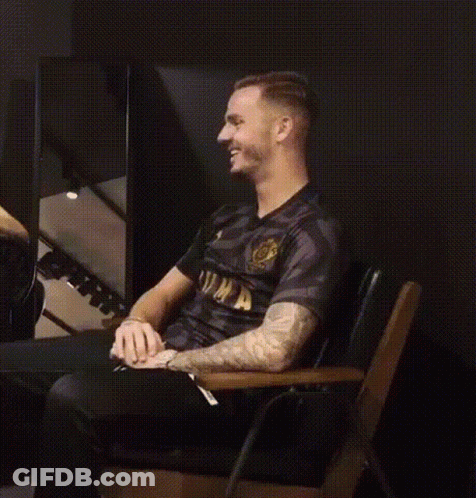 Man In Black Shirt Laughing In Chair GIF