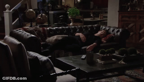 Man In Black Shirt Laying On Leather Couch GIF