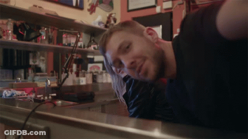 Man In Black Shirt Leaning On Counter GIF