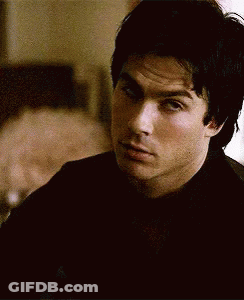 Man In Black Shirt Looking At Camera GIF