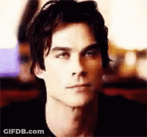Man In Black Shirt Looking At Camera GIF
