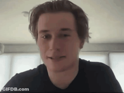 Man In Black Shirt Looking At Camera GIF