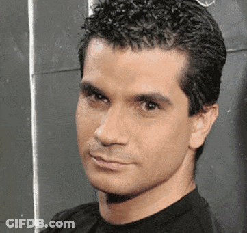 Man In Black Shirt Looking At Camera GIF