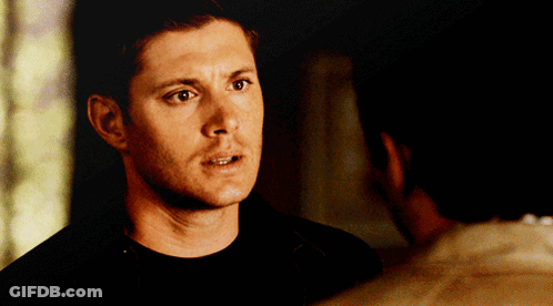 Man In Black Shirt Looking At Man In White Shirt GIF
